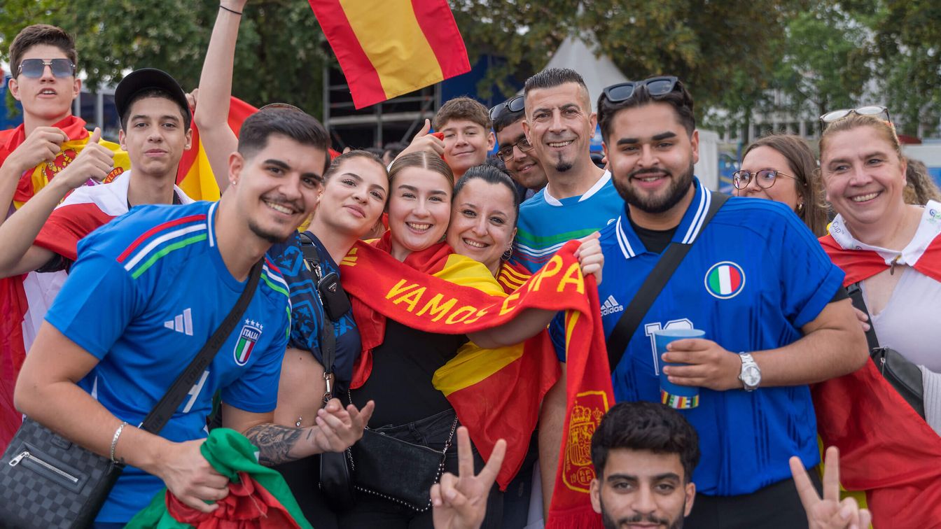 Fans of the Spanish team cheer for their team. 