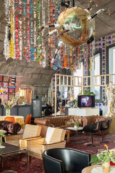 Artistically designed room with sofas, colourful origami cranes and creative furnishings.